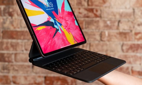 Holding-iPad-Pro-with-Magic-Keyboard-and-Track