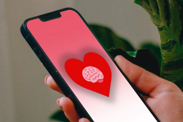 From iPhoneIslam.com, a person holding a red heart-shaped smartphone.