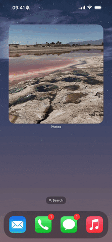 من iPhoneIslam.com، لقطة شاشة لجهاز iPhone تظهر منظرًا لبحيرة مع ميزات الكاميرا المخفية.