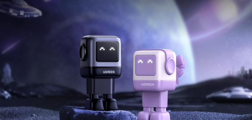 Do iPhoneIslam.com, dois personagens robôs da marca ugreen em uma paisagem espacial estilizada com uma nave espacial ao fundo.