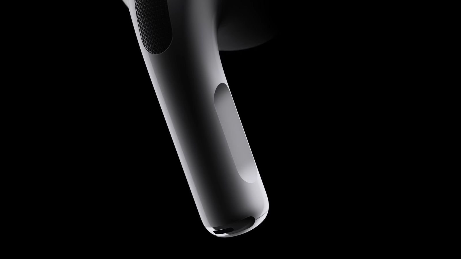 Dari iPhoneIslam.com, tampilan close-up AirPods hitam yang modern dan elegan dengan latar belakang gelap, menonjolkan desain dan teksturnya yang ramping.