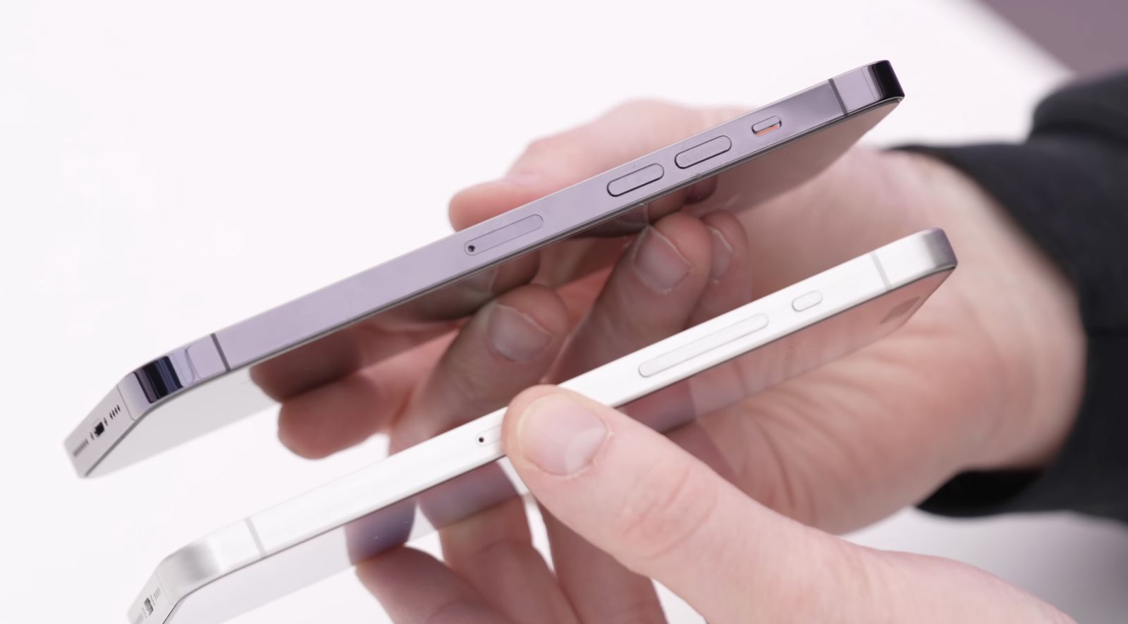 iPhoneIslam.com에서 흰색 배경에서 서로 다른 두 스마트폰의 두께와 디자인을 비교하는 두 손으로 19년 25월 2023~XNUMX일 주의 업데이트를 보여줍니다.