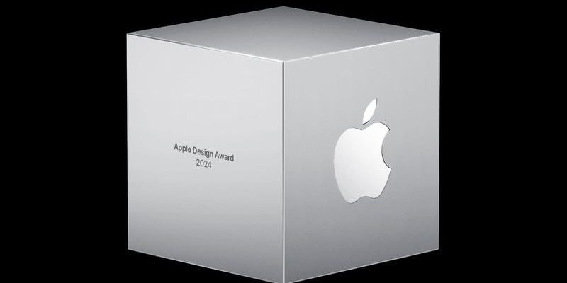 من iPhoneIslam.com، مكعب فضي عليه شعار Apple محفور عليه النص "Apple Design Award 2024"، ويظهر بشكل بارز في قسم الأخبار في نشرة مايو الإخبارية.