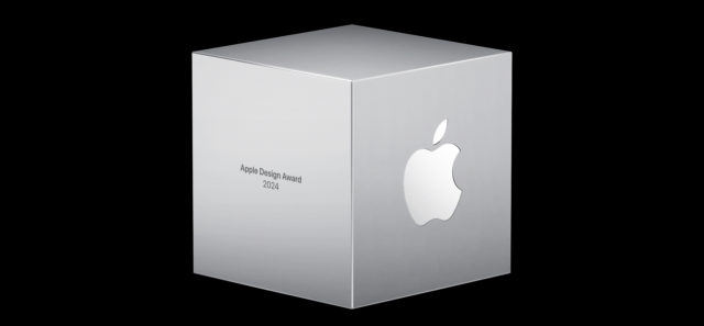 من iPhoneIslam.com، كأس فضي أنيق على شكل مكعب يحمل شعار Apple على جانب واحد ونص "Apple Design Award 2014" على الجانب الآخر، يقف بفخر على خلفية سوداء، احتفالاً بالعمل الاستثنائي للمتأهلين للتصفيات النهائية.