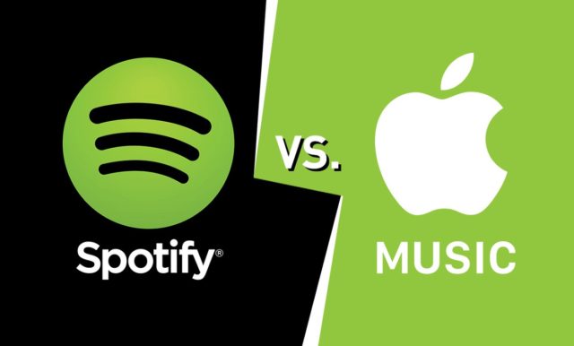 من iPhoneIslam.com، صورة تظهر شاشة مقسمة مع شعار Spotify على خلفية سوداء على اليسار وشعار Apple Music على خلفية خضراء على اليمين، مع "VS". في المنتصف. تطبيق تطعن في قرار الاتحاد الأوروبي يضيف إلى ضجة المنافسة.