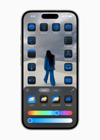 From iPhoneIslam.com, a smartphone screen showing apps on the home screen with an image of a person in blue clothes walking in the desert. The bottom shows customization options for app icon sizes and background color themes, which have become easier with the iOS 18 update. Customizing the home screen has become easier on your iPhone.