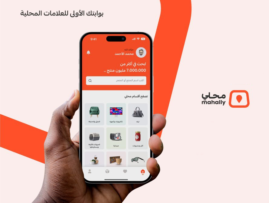 من iPhoneIslam.com، يد تحمل هاتفًا ذكيًا يعرض التطبيق المحلي باللغة العربية، ويعرض منتجات متنوعة. يظهر الشعار والنص "Mahally" على الجانب الأيمن، مما يربطك بسوق السعودية بسهولة.