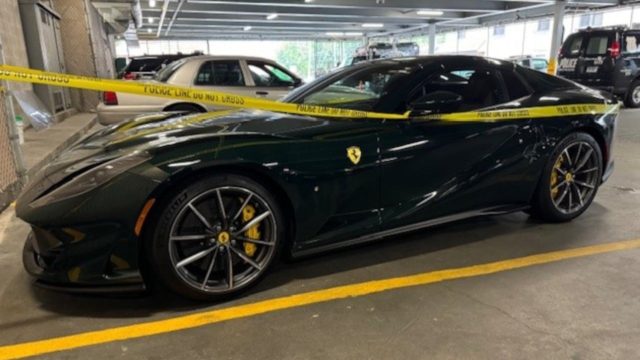 From iPhoneIslam.com, a dark green Ferrari sports car, worth half a million dollars, is parked in a covered area, surrounded by yellow police tape.