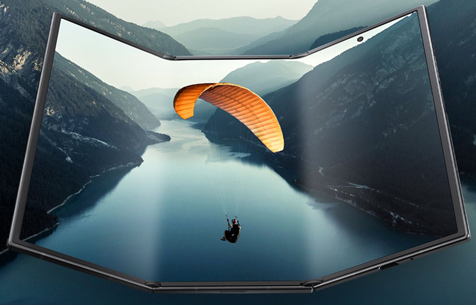 من موقع فون إسلام: تعرض شاشة عرض قابلة للطي صورة طائرة شراعية فوق وادي نهر, تندمج بسلاسة مع المناظر الطبيعية الجبلية المحيطة بها - وهو ما يبرز في هذا الأسبوع ضمن ملخص ملخص أسبوعي لأهم الأخبار في عالم أخبار التقنية.