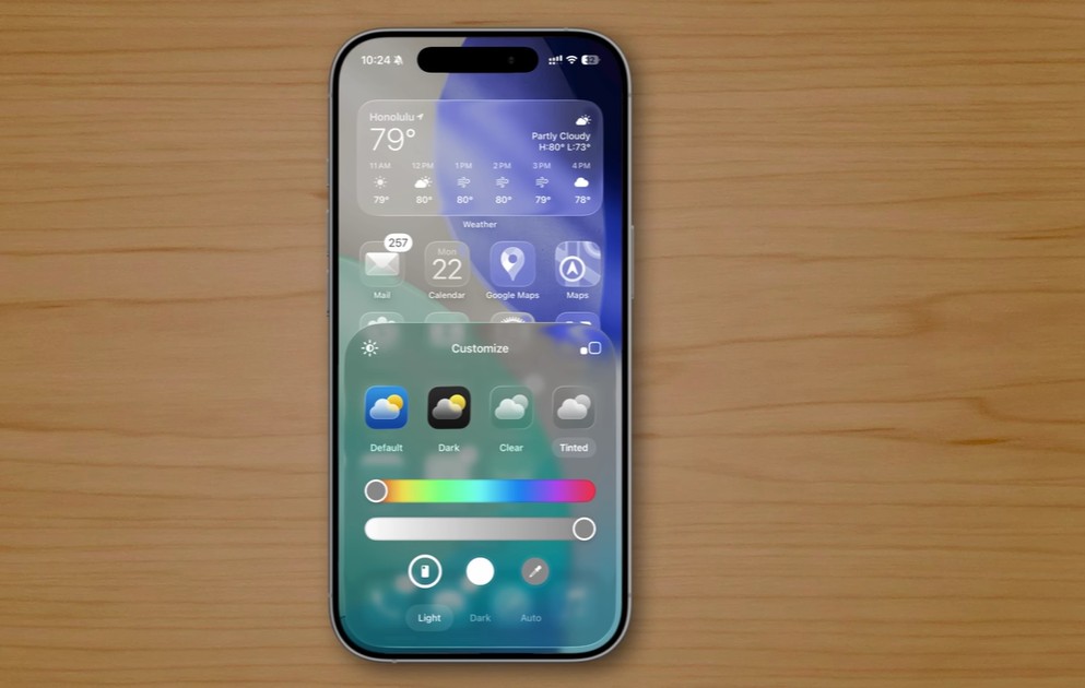 من موقع فون إسلام: يعرض الهاتف الذكي الذي يعمل بنظام iOS 26 على سطح خشبي تطبيق الطقس وخيارات التخصيص لمظهر الأداة، بما في ذلك إعدادات اللون ووضع الإضاءة/الإضاءة/الظلام، وميزات خفية لتحسين تجربة الآي-فون.