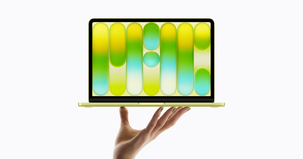 من موقع فون إسلام: يد تحمل حاسوباً محمولاً أصفر اللون مع شاشة تعرض نمطاً تجريدياً بألوان الأخضر والأصفر والأزرق على خلفية بيضاء.