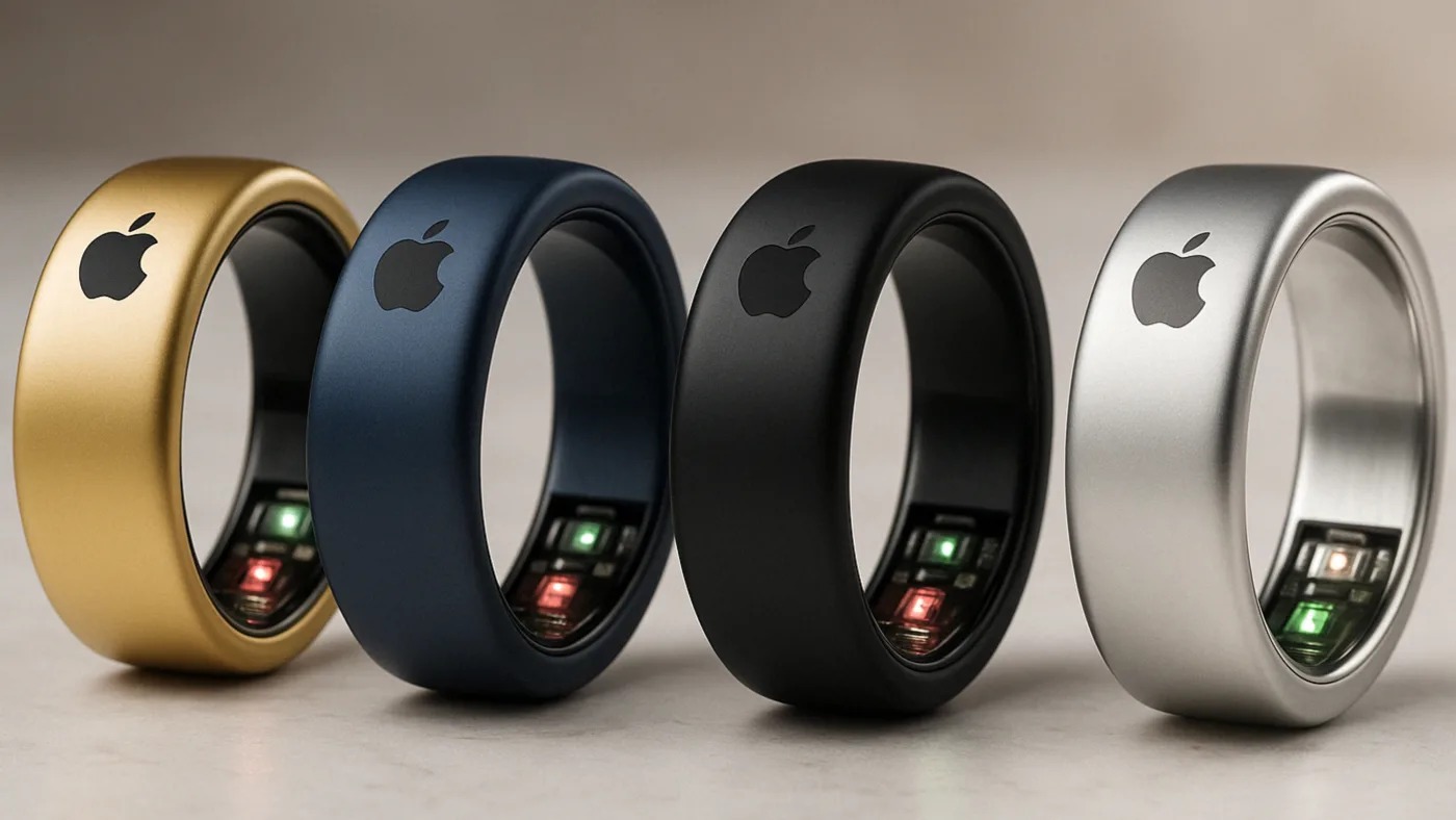 من موقع فون إسلام: أربعة خواتم ذكية معدنية باللون الذهبي والأزرق والأسود والفضي، تتميز كل منها بشعار Apple ومستشعرات مدمجة على الجانب الداخلي - مما يوفر لك خاتم آبل الذكي للاتصال والأناقة السلس.