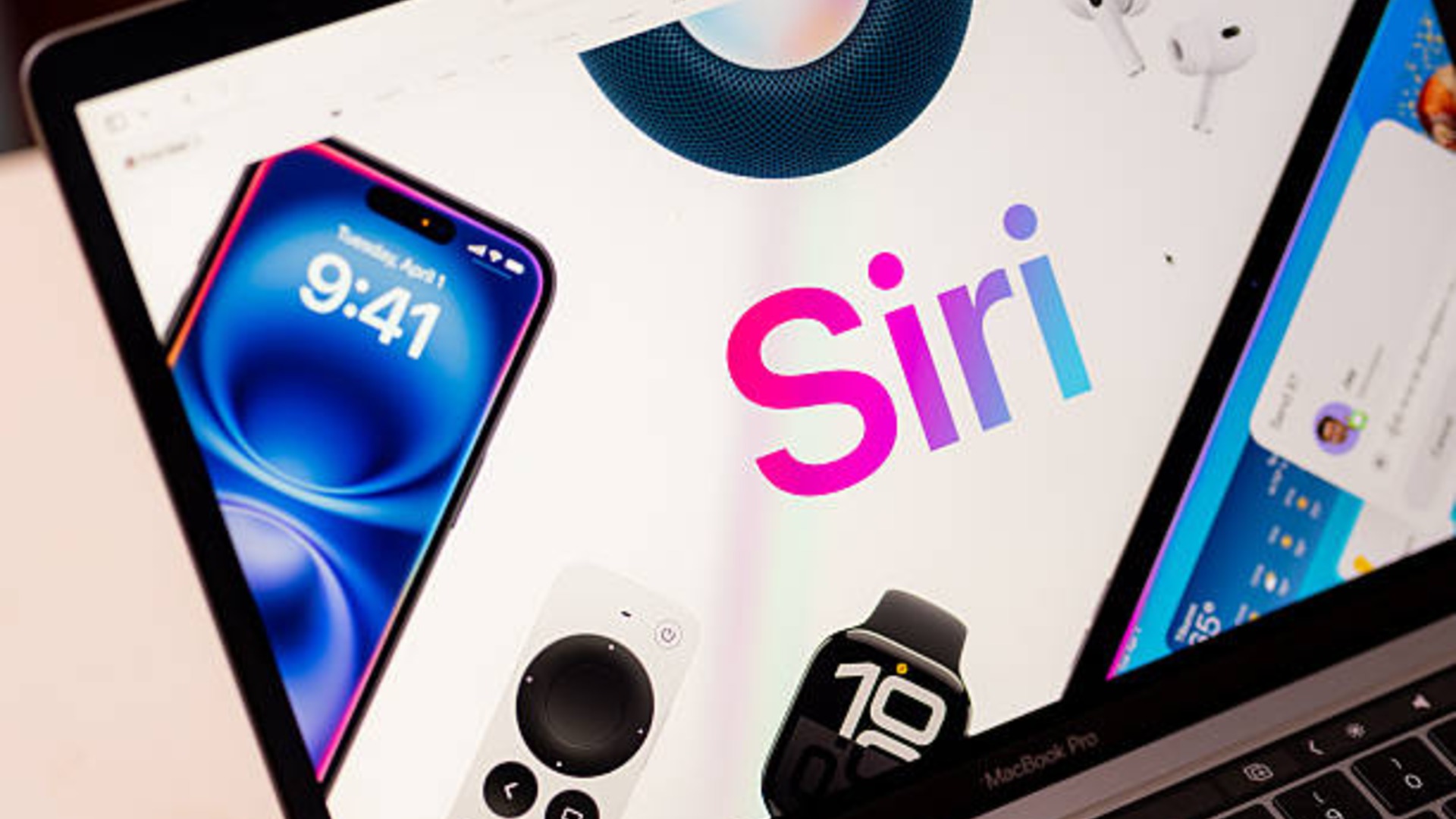 من موقع فون إسلام: تعرض شاشة كمبيوتر محمول شعار Siri إلى جانب صور لجهاز iPhone و Apple Watch و Apple TV عن بُعد و HomePod و AirPods، مع تسليط الضوء على ميزات من تحديث سيري iOS 27.