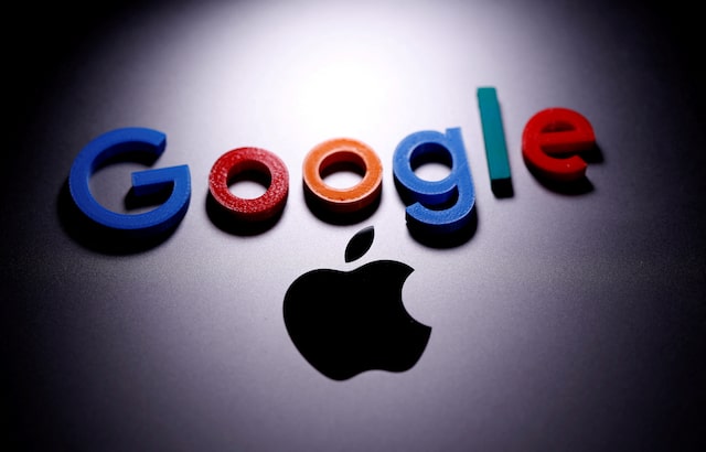 من موقع فون إسلام: شعار Google بأحرف ملونة موضوع فوق شعار Apple أسود على سطح مظلم، مضاءً بمصباح كشاف، في مشهد يعكس أخبار التقنية وملخص للأحداث.
