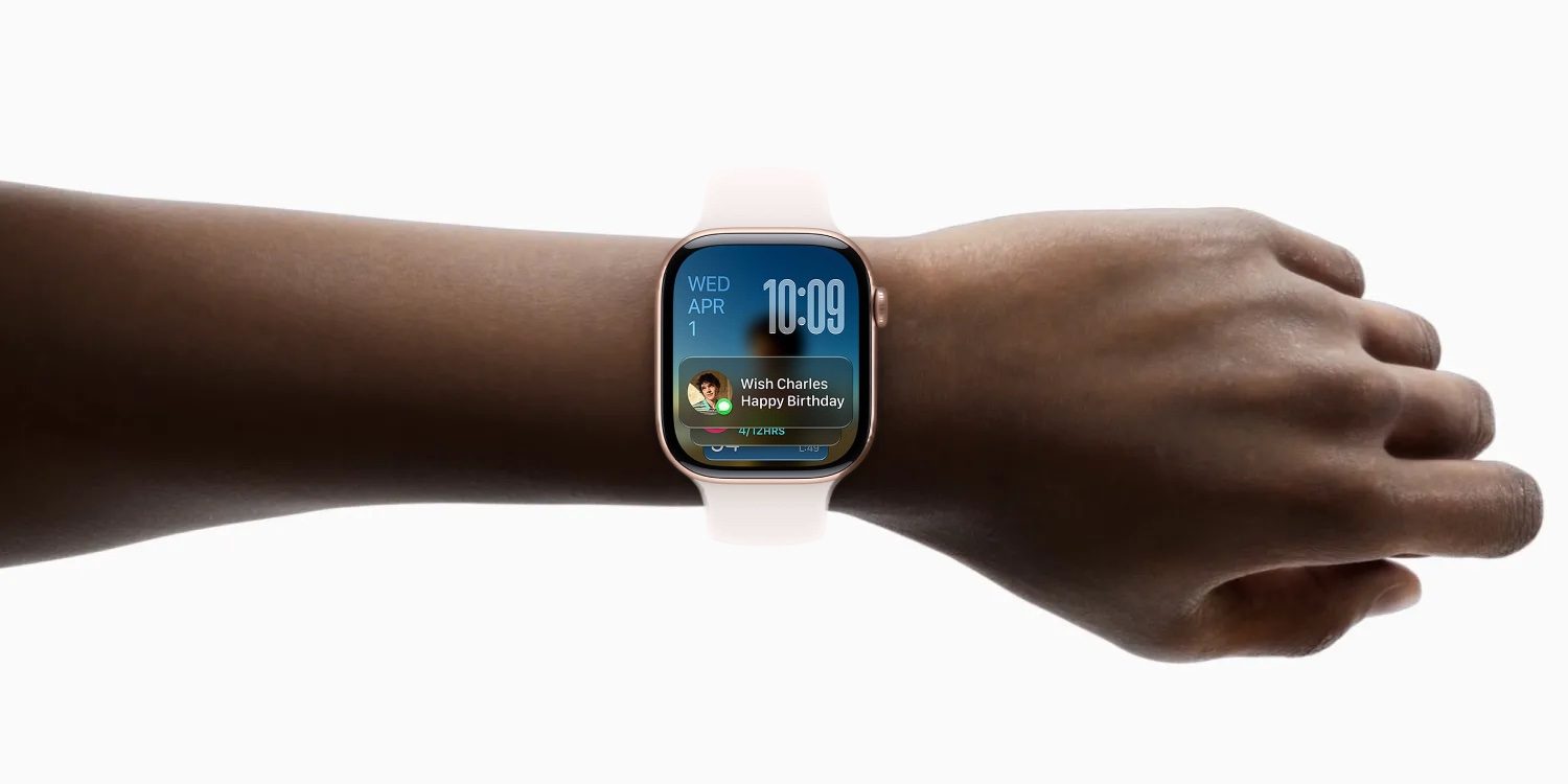 From Phonegram: A smartwatch with a white band on someone's wrist shows the time, date, and a birthday greeting notification using watchOS 27.