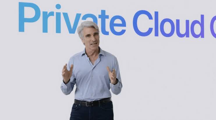 From Phonegram: A gray-haired man in a blue shirt stands in front of a screen displaying the words 'Private Cloud', gesturing with his hands, likely explaining the new features for documenting iPhone photos in iOS 27.