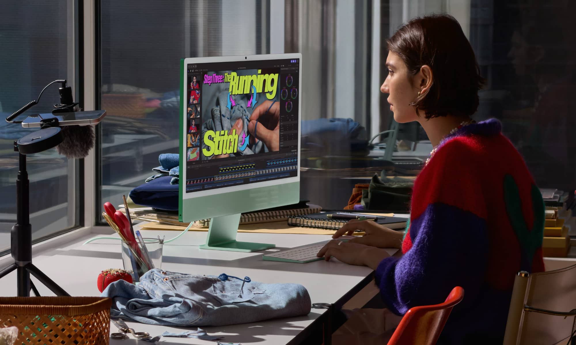 A woman editing video using the new iMac