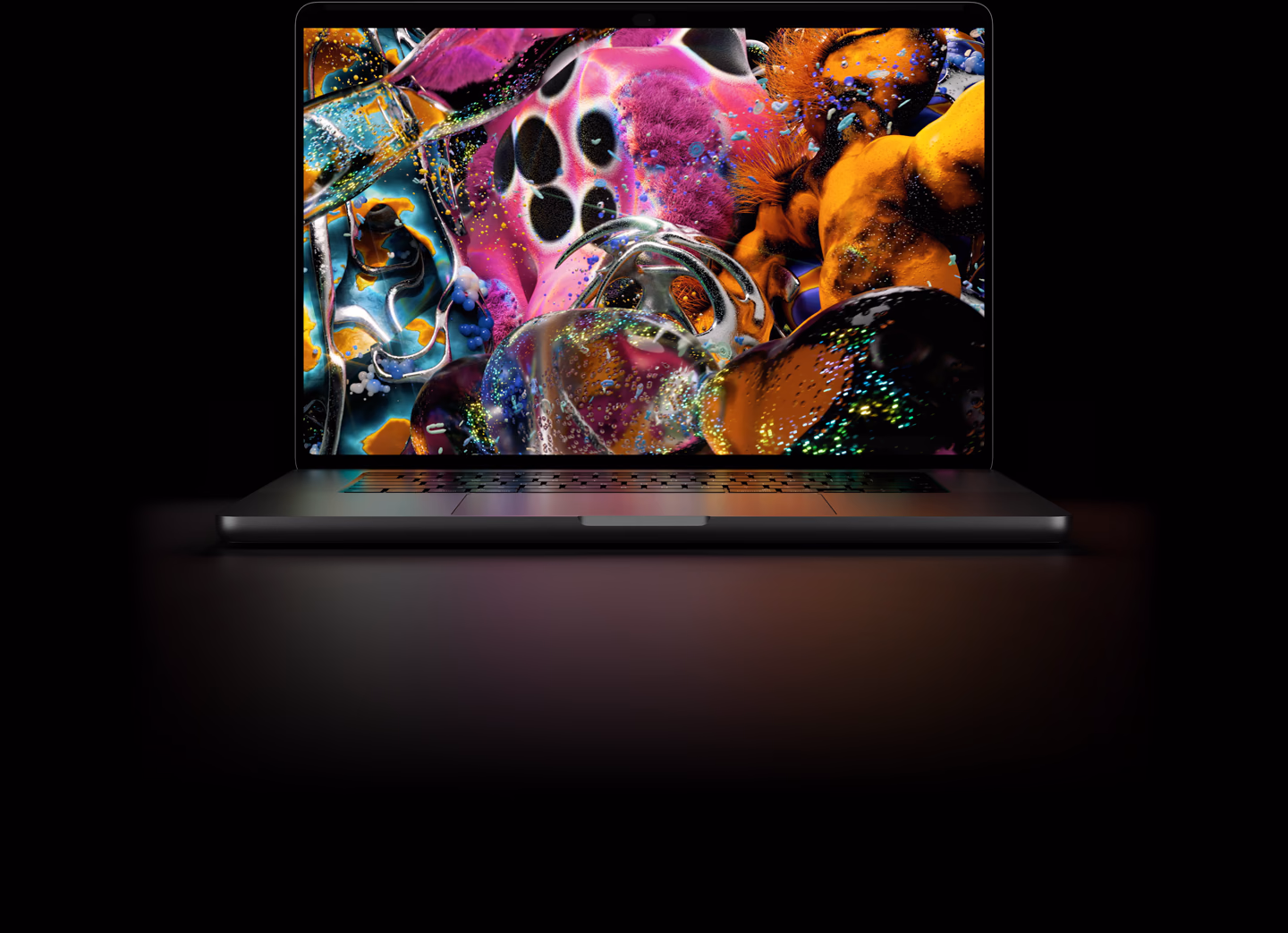 من موقع فون إسلام: جهاز MacBook Pro يعرض على شاشته عملاً فنياً رقمياً تجريدياً بألوان زاهية.