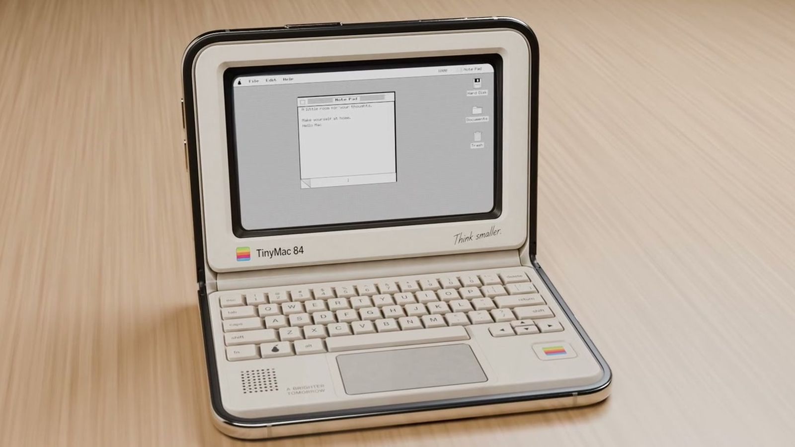من موقع فون إسلام: جهاز كمبيوتر محمول مصغر بتصميم كلاسيكي يحمل اسم «TinyMac 84»، تظهر على شاشته واجهة سطح مكتب كلاسيكية على غرار أجهزة ماكنتوش.